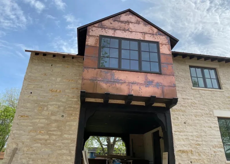 Copper metal panel facade on a stone building for Skylight Installation in Ellensburg